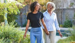 2 women walking in the garden