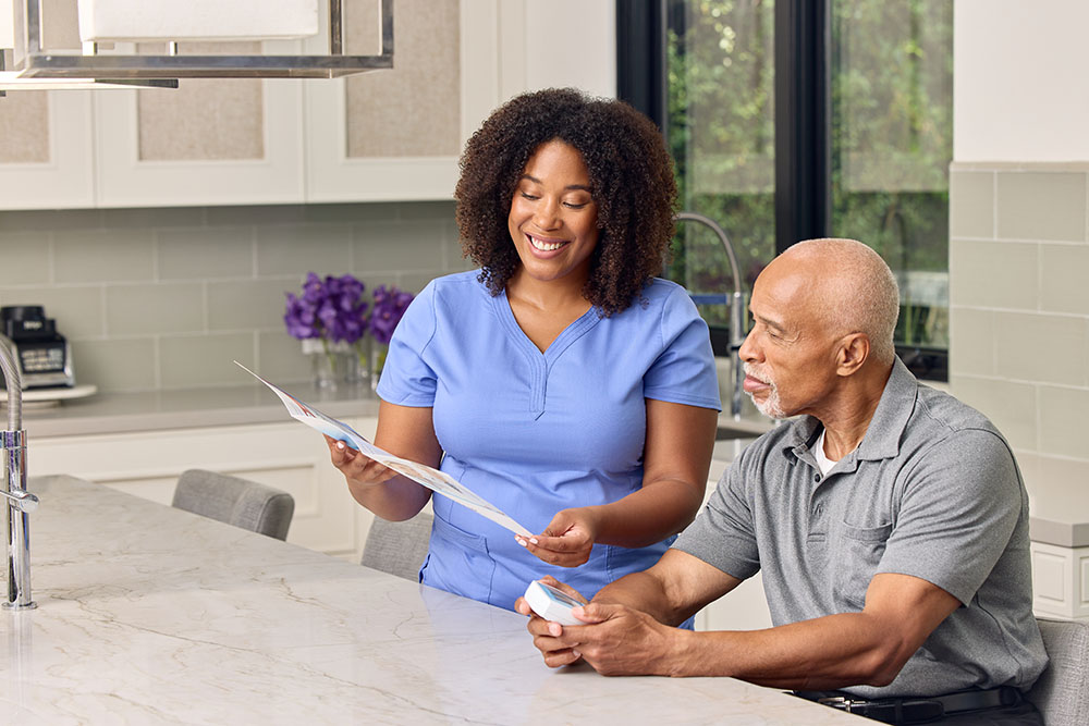 clinician showing patient how to use an INR device